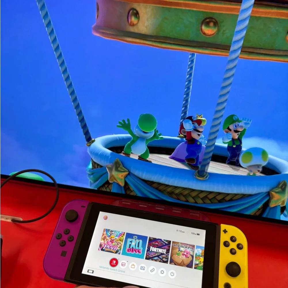 Nintendo Switch with Vibrant Purple and Yellow Joy-Con free games